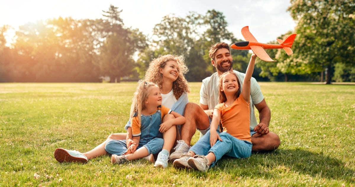 A happy family sitting on a lawn