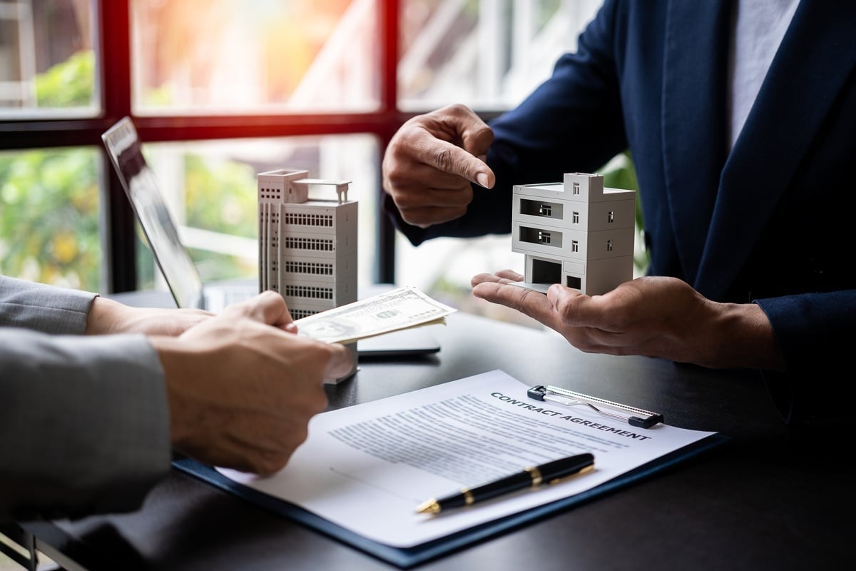 Businessman pointing at a model of a commercial building