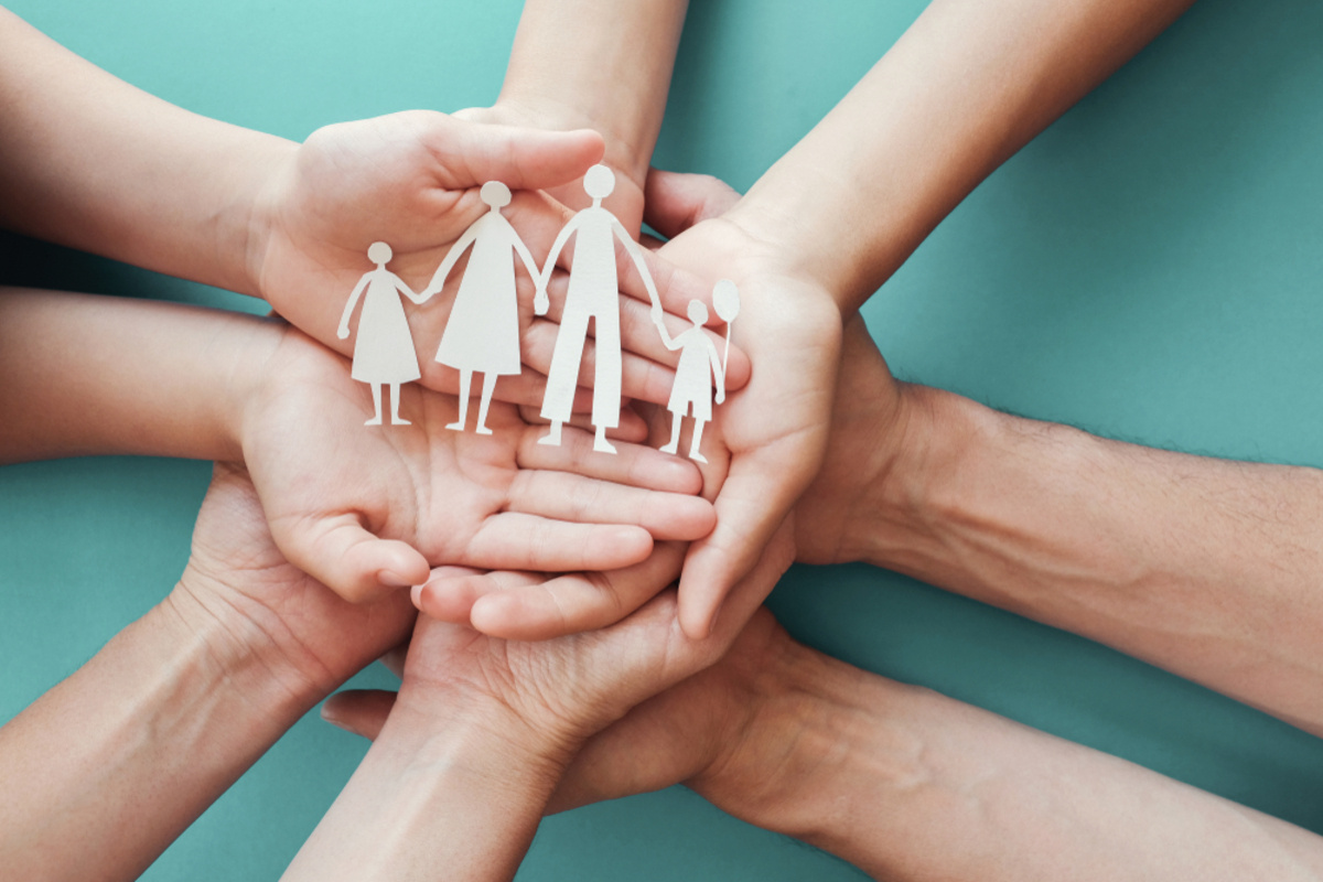 Hands holding a cutout family